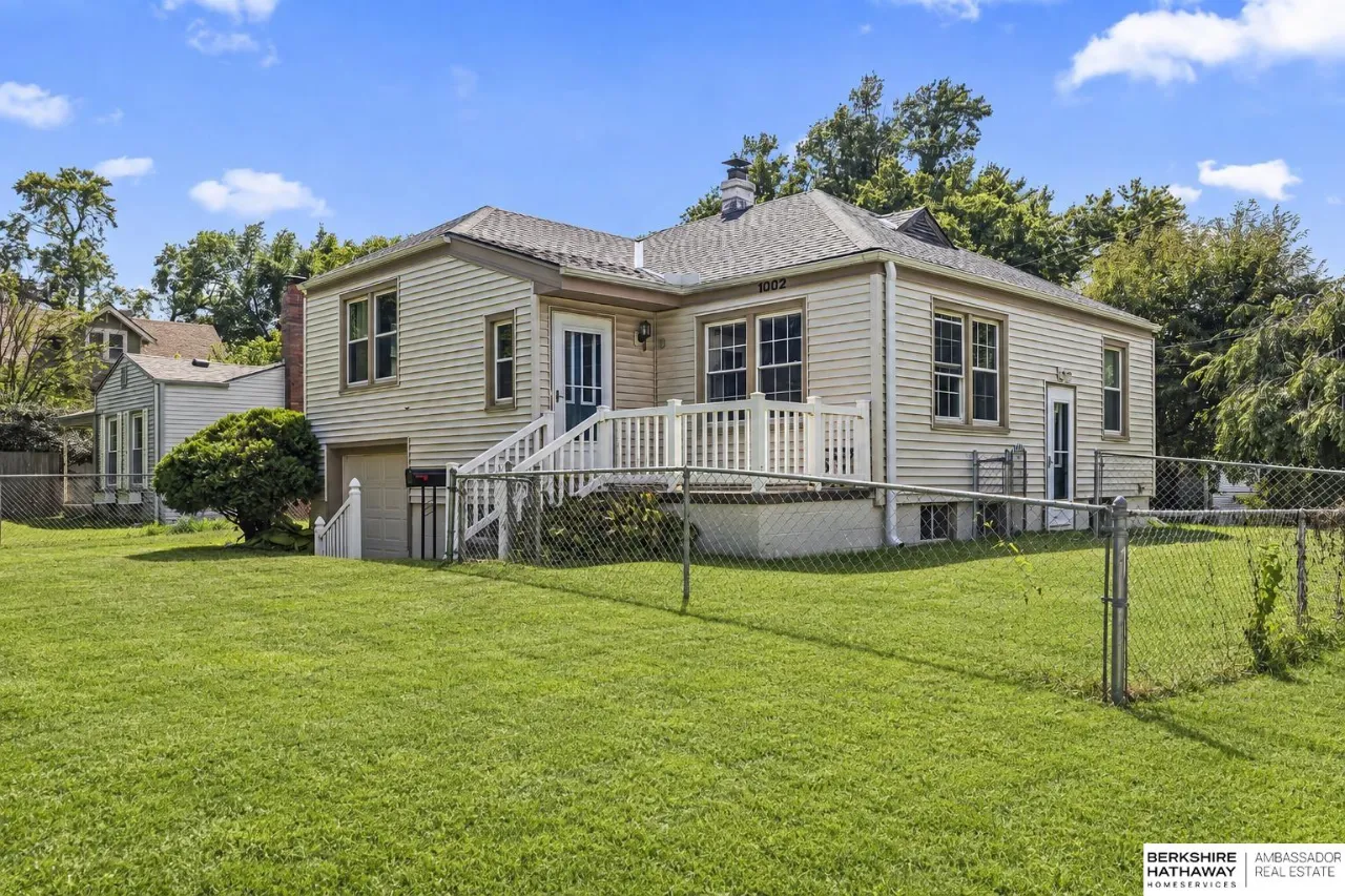 House at 1002 S 52nd Street with a raised white deck and fenced lawn.